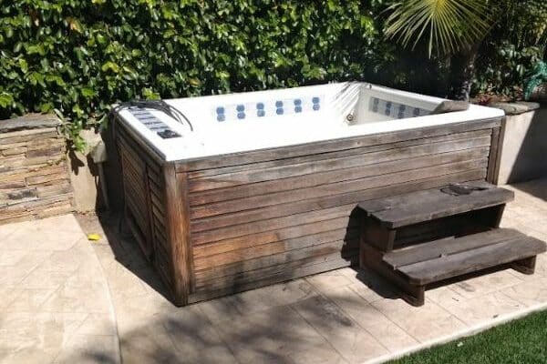 Old hot tub ready for removal in a backyard in Winter Haven, FL.